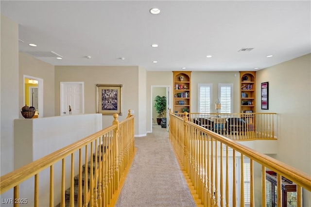 6440 Bristlebird St, North Las Vegas, NV 89084 - hallway with an upstairs landing, recessed lighting, light colored carpet, built in features, and baseboards