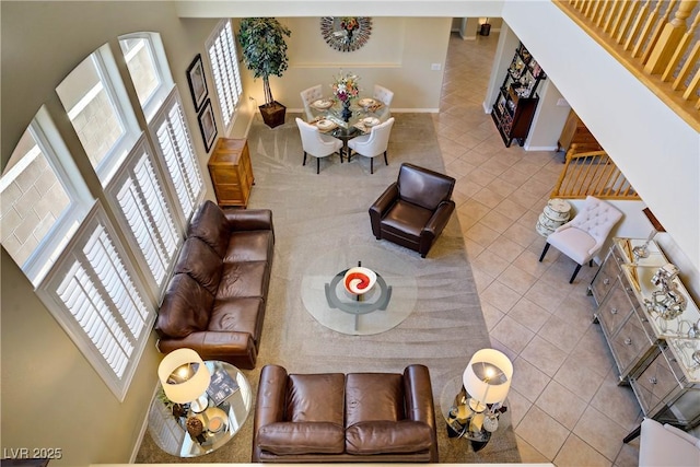 6440 Bristlebird St, North Las Vegas, NV 89084 - tiled living room featuring healthy amount of natural light, baseboards, and a towering ceiling