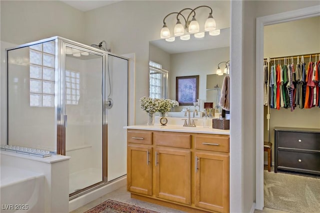 6440 Bristlebird St, North Las Vegas, NV 89084 - bathroom featuring a shower stall, vanity, a garden tub, and a walk in closet