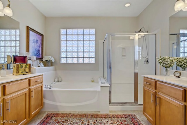 6440 Bristlebird St, North Las Vegas, NV 89084 - bathroom with a stall shower, two vanities, a bath, and recessed lighting