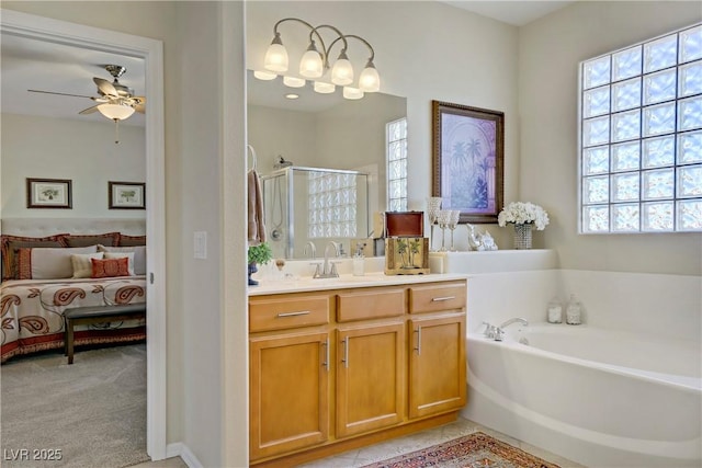 6440 Bristlebird St, North Las Vegas, NV 89084 - ensuite bathroom featuring a shower stall, vanity, a garden tub, and ceiling fan