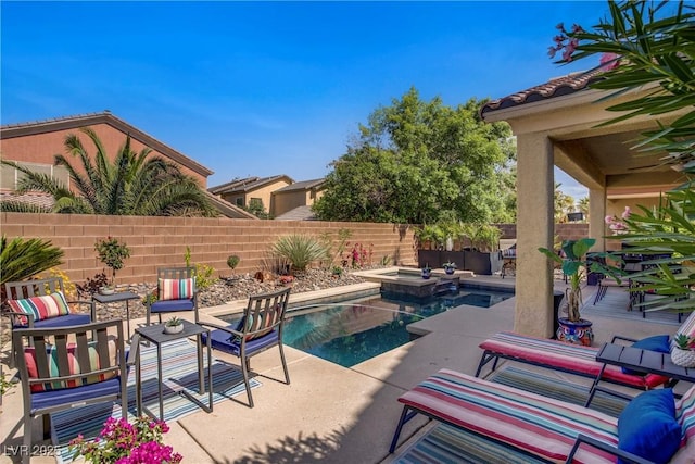 6440 Bristlebird St, North Las Vegas, NV 89084 - view of swimming pool featuring a fenced backyard, a patio area, and a pool with connected hot tub