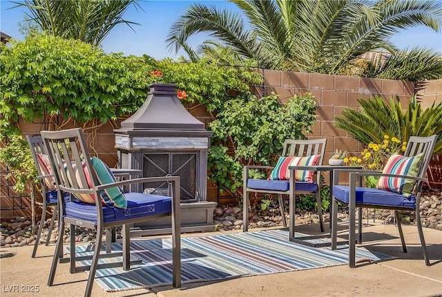 6440 Bristlebird St, North Las Vegas, NV 89084 - view of patio / terrace with exterior fireplace