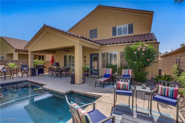 6440 Bristlebird St, North Las Vegas, NV 89084 - back of house featuring stucco siding, ceiling fan, a patio area, a tiled roof, and outdoor dining area