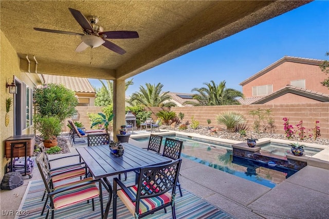 6440 Bristlebird St, North Las Vegas, NV 89084 - fenced backyard featuring a patio area, a ceiling fan, outdoor dining space, and a pool with connected hot tub