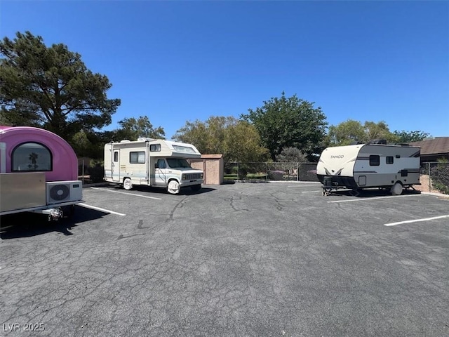 6445 Ironbark Ln, Las Vegas, NV 89107 - uncovered parking lot with a cooling unit