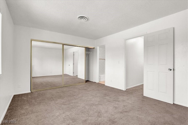 6445 Ironbark Ln, Las Vegas, NV 89107 - unfurnished bedroom with carpet flooring, a closet, and a textured ceiling