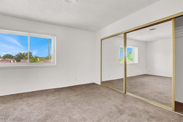 6445 Ironbark Ln, Las Vegas, NV 89107 - unfurnished bedroom with carpet flooring, a textured ceiling, and a closet