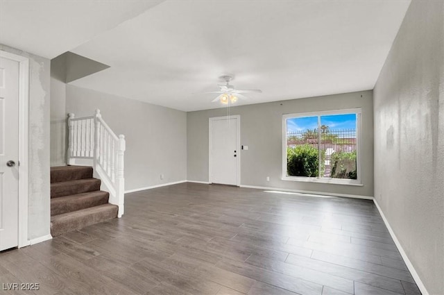 6445 Ironbark Ln, Las Vegas, NV 89107 - unfurnished living room featuring dark wood-style floors, ceiling fan, and stairway