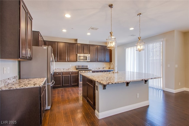 2369 Via Barranca St, Henderson, NV 89044 - kitchen featuring appliances with stainless steel finishes, dark wood-style floors, dark brown cabinetry, a sink, and recessed lighting