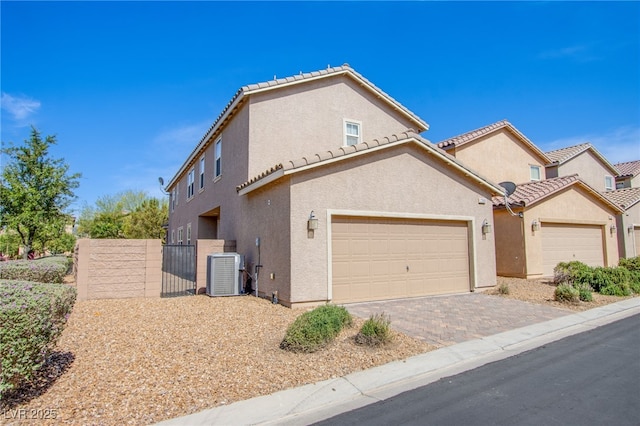 2369 Via Barranca St, Henderson, NV 89044 - view of front of home featuring cooling unit, stucco siding, a gate, a tiled roof, and driveway