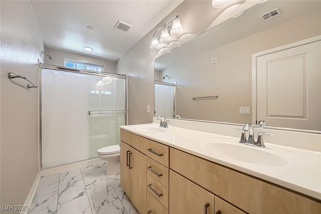 9050 W Tropicana Ave Unit 1015, Las Vegas, NV 89147 - full bath with double vanity, toilet, a shower stall, marble finish flooring, and baseboards