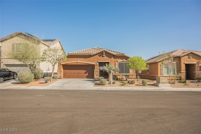 132 Soaring Sky Ave, Henderson, NV 89011 - mediterranean / spanish-style home featuring a garage, concrete driveway, roof mounted solar panels, stucco siding, and a tile roof