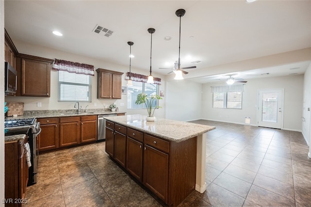 132 Soaring Sky Ave, Henderson, NV 89011 - kitchen with stainless steel appliances, a sink, ceiling fan, plenty of natural light, and recessed lighting