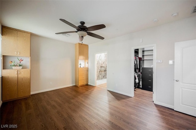 132 Soaring Sky Ave, Henderson, NV 89011 - unfurnished bedroom featuring a spacious closet, wood finished floors, and baseboards
