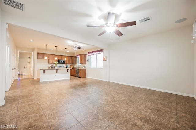 132 Soaring Sky Ave, Henderson, NV 89011 - unfurnished living room with ceiling fan, baseboards, and light tile patterned floors
