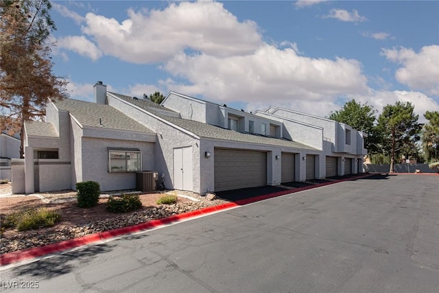 5523 Orchard Ln Unit 0, Las Vegas, NV 89110 - view of front of property with central AC, stucco siding, and community garages