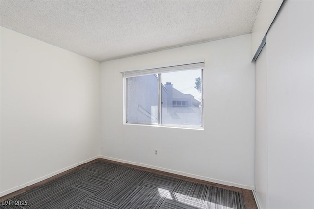5523 Orchard Ln Unit 0, Las Vegas, NV 89110 - spare room with a textured ceiling, baseboards, and dark carpet