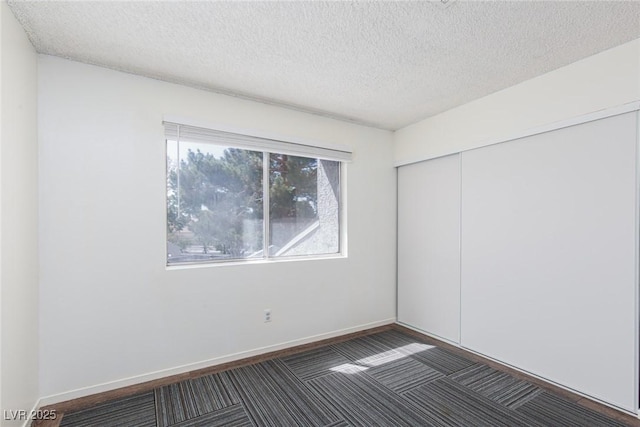 5523 Orchard Ln Unit 0, Las Vegas, NV 89110 - unfurnished bedroom with a closet, a textured ceiling, carpet flooring, and baseboards