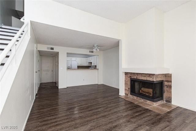 5523 Orchard Ln Unit 0, Las Vegas, NV 89110 - unfurnished living room featuring dark wood finished floors, ceiling fan, stairs, and a tiled fireplace