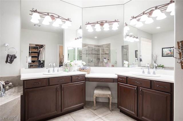 7538 Mustang St, Las Vegas, NV 89131 - bathroom featuring a stall shower, two vanities, tile patterned floors, and a spacious closet