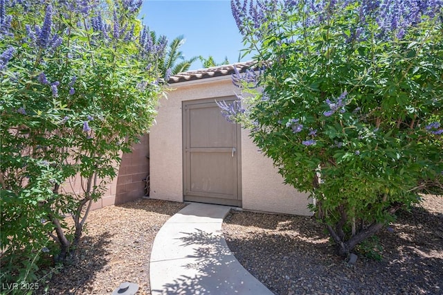 7538 Mustang St, Las Vegas, NV 89131 - doorway to property featuring stucco siding and a tiled roof