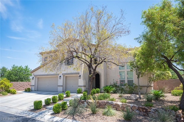 7538 Mustang St, Las Vegas, NV 89131 - view of front of house featuring stucco siding, concrete driveway, and an attached garage