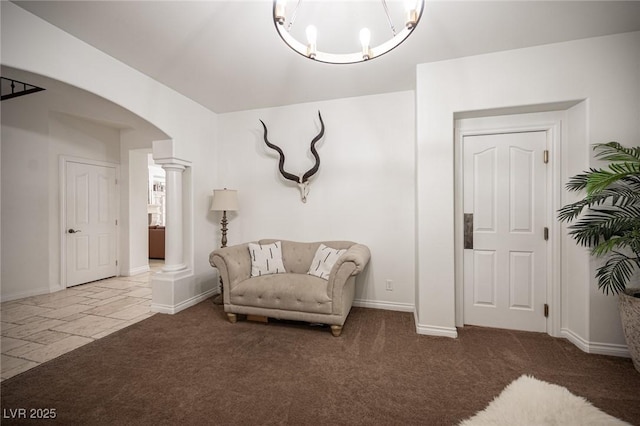 7538 Mustang St, Las Vegas, NV 89131 - living area with decorative columns, arched walkways, a chandelier, baseboards, and carpet