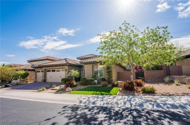 2896 Grande Arch St, Henderson, NV 89044 - view of front of property featuring stucco siding, a tiled roof, a garage, and asphalt driveway