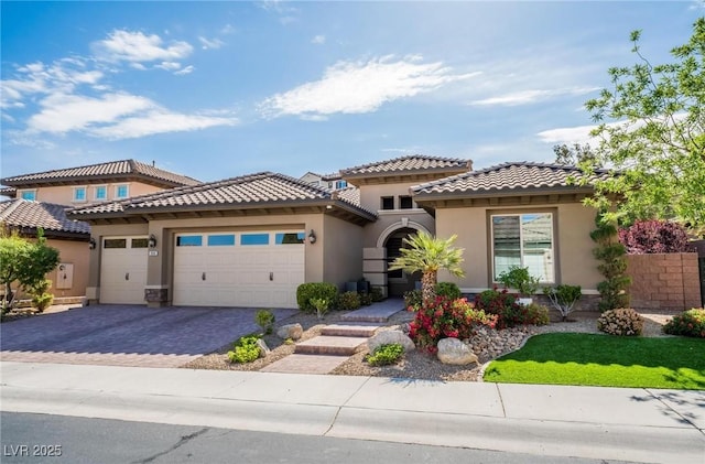 2896 Grande Arch St, Henderson, NV 89044 - mediterranean / spanish house with stucco siding, a tiled roof, a garage, and decorative driveway