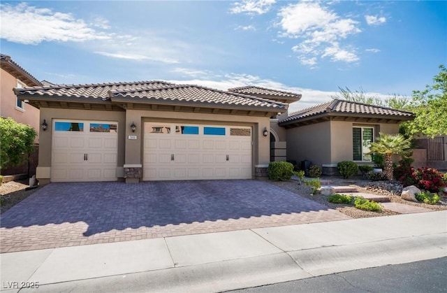 2896 Grande Arch St, Henderson, NV 89044 - view of front of home featuring stucco siding, decorative driveway, an attached garage, and a tiled roof