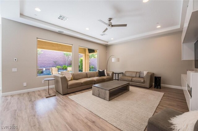 2896 Grande Arch St, Henderson, NV 89044 - living area with a raised ceiling, a ceiling fan, recessed lighting, and light wood-style flooring