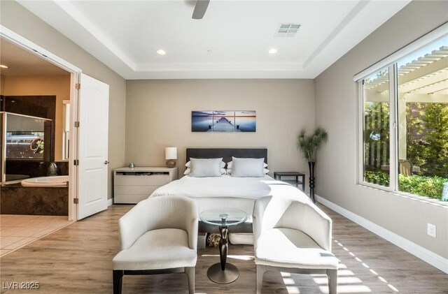 2896 Grande Arch St, Henderson, NV 89044 - bedroom featuring multiple windows, light wood finished floors, recessed lighting, baseboards, and a raised ceiling