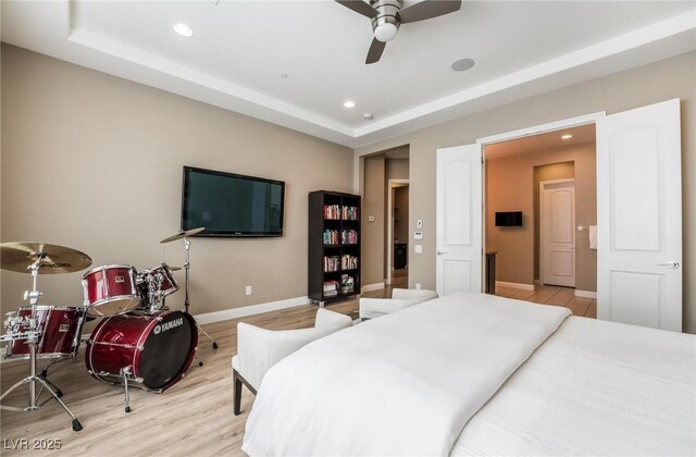 2896 Grande Arch St, Henderson, NV 89044 - bedroom with light wood-style flooring, recessed lighting, baseboards, a raised ceiling, and a ceiling fan