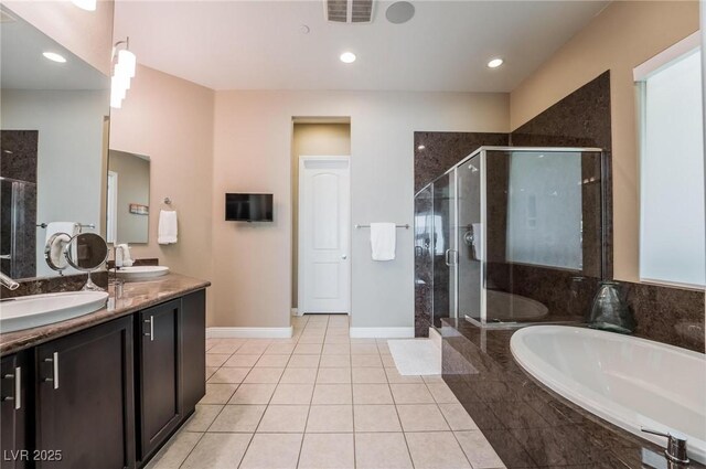 2896 Grande Arch St, Henderson, NV 89044 - full bath featuring a garden tub, double vanity, a stall shower, tile patterned flooring, and baseboards