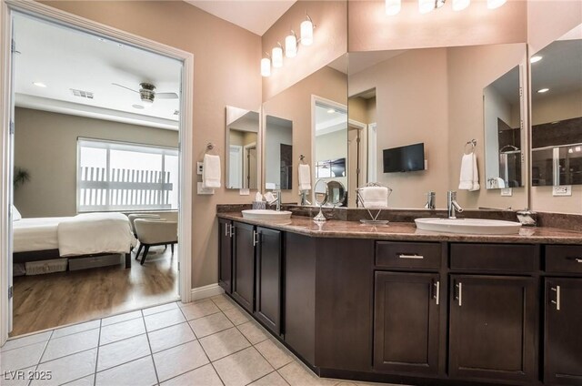 2896 Grande Arch St, Henderson, NV 89044 - ensuite bathroom with double vanity, tile patterned floors, and baseboards