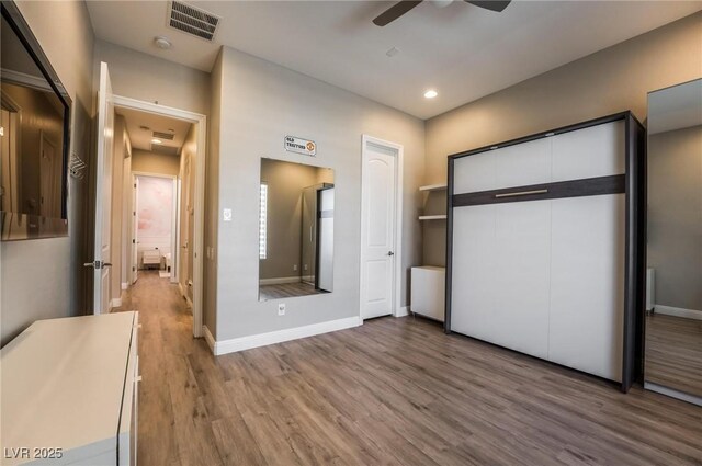 2896 Grande Arch St, Henderson, NV 89044 - unfurnished bedroom with wood finished floors, recessed lighting, baseboards, ceiling fan, and a closet