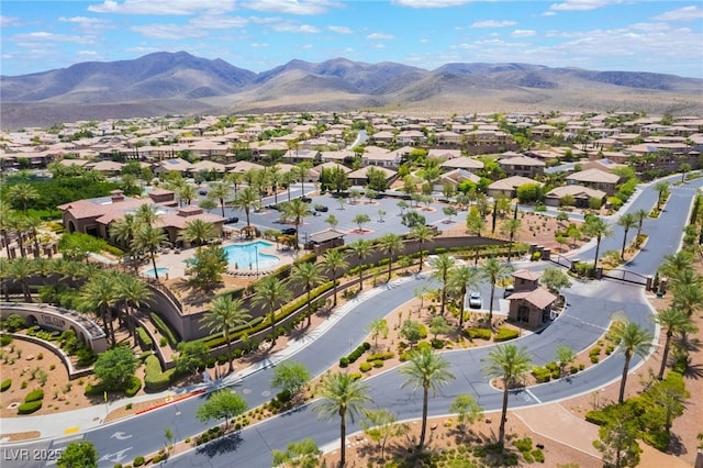 2896 Grande Arch St, Henderson, NV 89044 - aerial perspective of suburban area with a mountainous background and a pool area