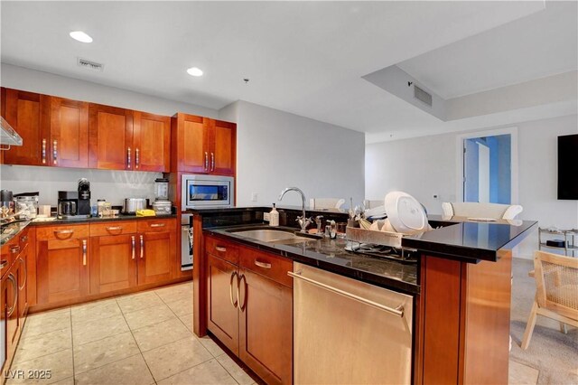 4525 Dean Martin Dr Unit 2109, Las Vegas, NV 89103 - kitchen featuring stainless steel appliances, a sink, dark countertops, an island with sink, and recessed lighting