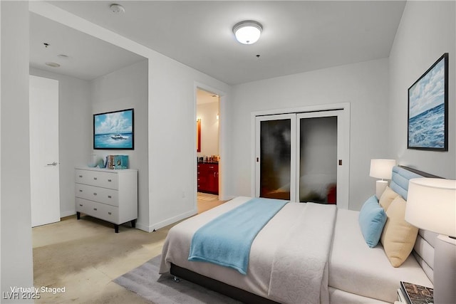 4525 Dean Martin Dr Unit 2109, Las Vegas, NV 89103 - bedroom featuring light carpet, baseboards, and ensuite bathroom