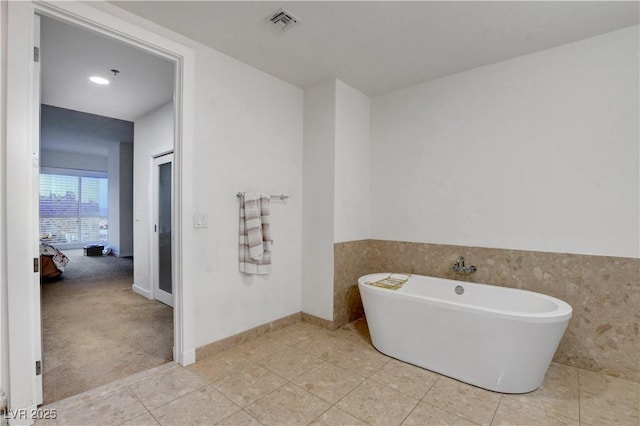 4525 Dean Martin Dr Unit 2109, Las Vegas, NV 89103 - full bath with a freestanding bath, tile patterned flooring, and baseboards