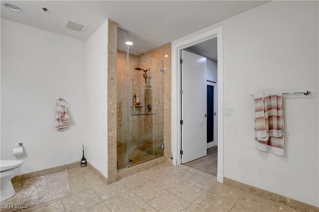 4525 Dean Martin Dr Unit 2109, Las Vegas, NV 89103 - bathroom with a stall shower, toilet, baseboards, and tile patterned floors