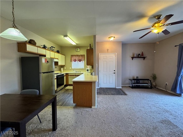 5750 E Hacienda Ave Unit 107, Las Vegas, NV 89122 - kitchen with white gas stove, freestanding refrigerator, a peninsula, light countertops, and a ceiling fan