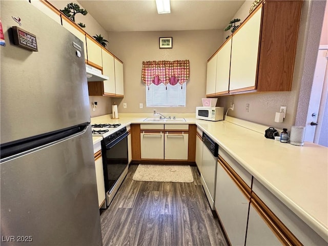 5750 E Hacienda Ave Unit 107, Las Vegas, NV 89122 - kitchen featuring white appliances, dark wood-style flooring, under cabinet range hood, and light countertops