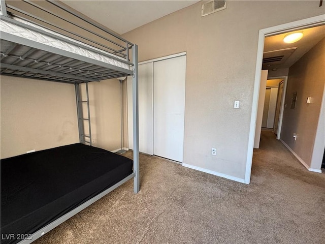 5750 E Hacienda Ave Unit 107, Las Vegas, NV 89122 - unfurnished bedroom featuring carpet flooring and a closet