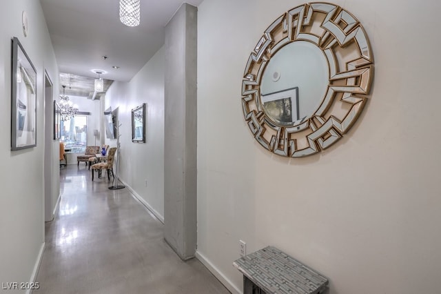 900 Las Vegas Blvd Unit 1208, Las Vegas, NV 89101 - hallway featuring baseboards, a chandelier, and concrete flooring