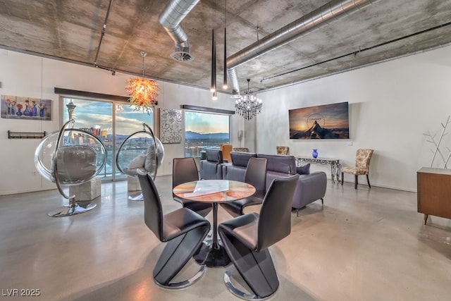 900 Las Vegas Blvd Unit 1208, Las Vegas, NV 89101 - dining space featuring finished concrete flooring, a chandelier, and baseboards