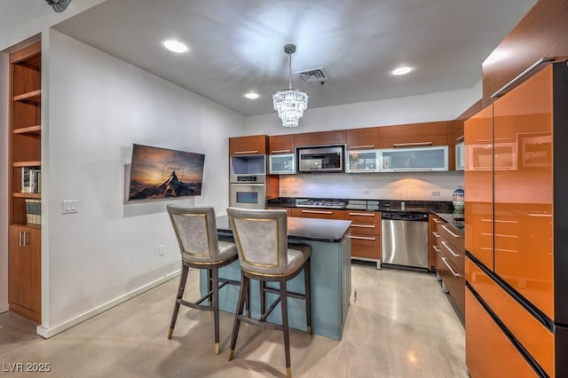 900 Las Vegas Blvd Unit 1208, Las Vegas, NV 89101 - kitchen with stainless steel appliances, dark countertops, a breakfast bar area, a chandelier, and a center island