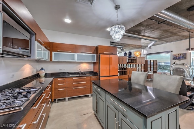 900 Las Vegas Blvd Unit 1208, Las Vegas, NV 89101 - kitchen featuring appliances with stainless steel finishes, a sink, a chandelier, pendant lighting, and concrete flooring