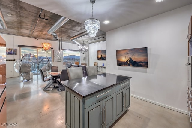 900 Las Vegas Blvd Unit 1208, Las Vegas, NV 89101 - kitchen featuring a chandelier, finished concrete floors, dark countertops, open floor plan, and pendant lighting